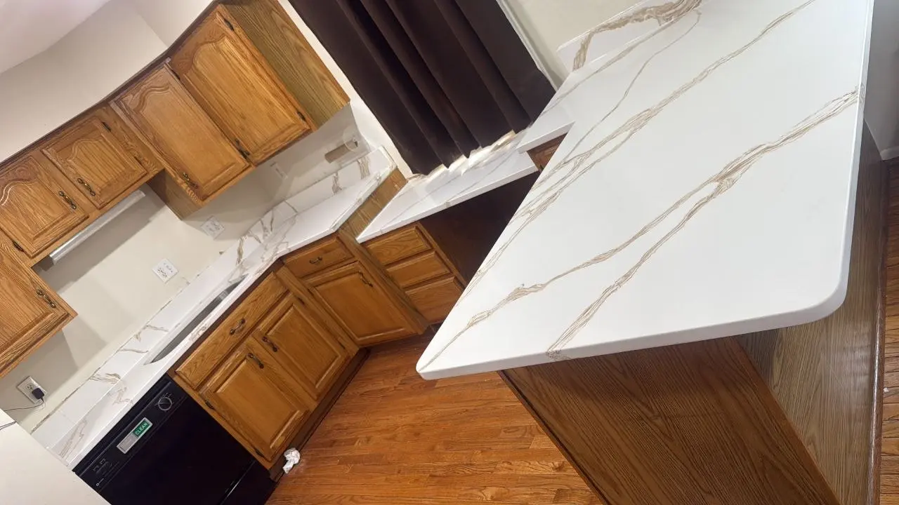 Kitchen with white stone countertops and gold veining