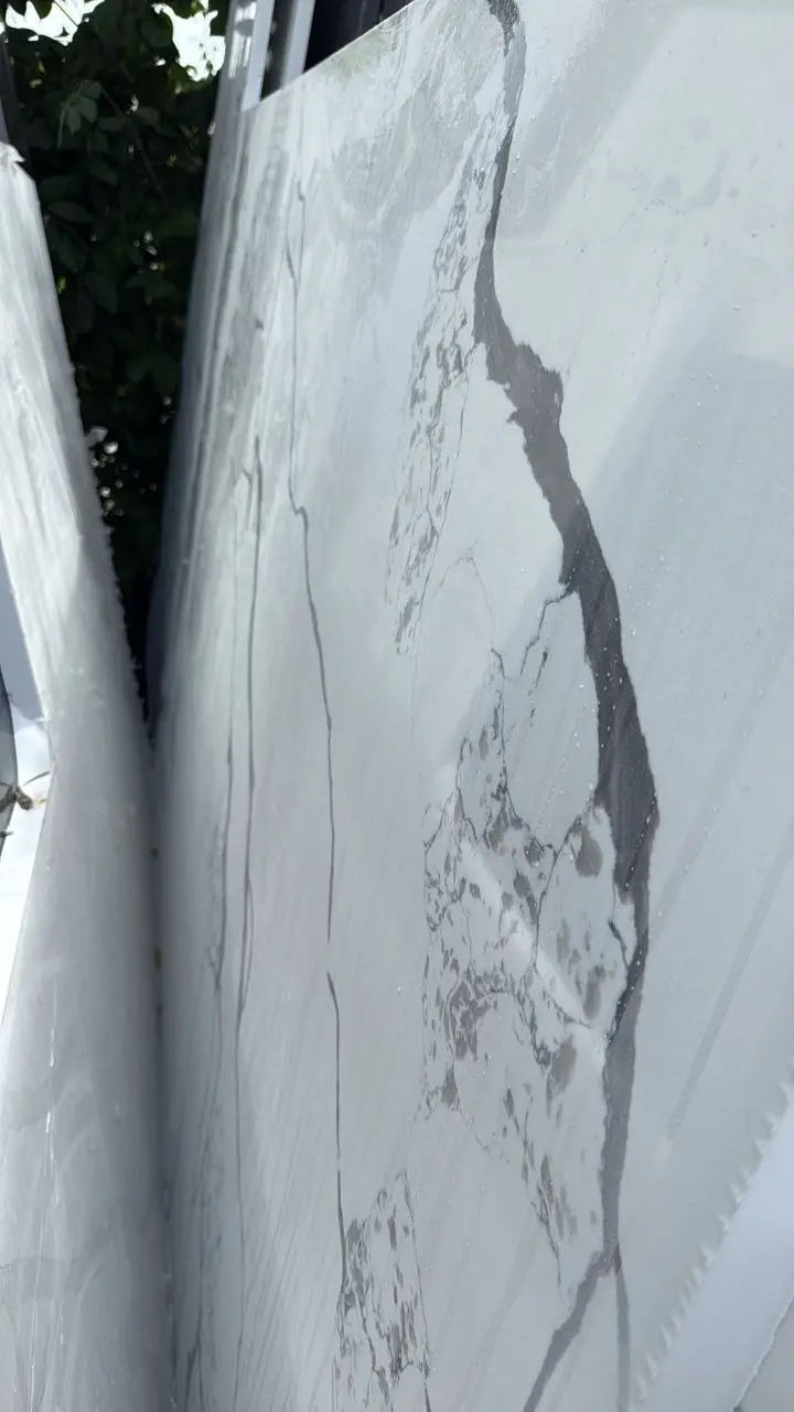 Close view of a white stone slab with dramatic gray veining