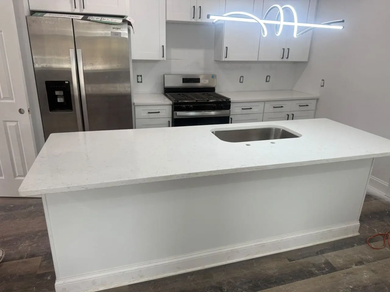 Finished white quartz kitchen island with undermount sink